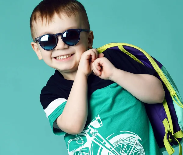 Przedszkola chłopiec dziecko stojąc z plecaka i okulary w szorty i koszulkę na zielonej mięty — Zdjęcie stockowe