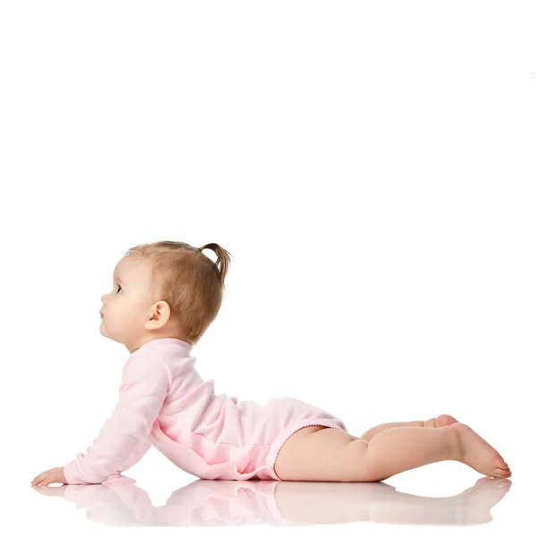 8 month infant child baby girl toddler lying in pink shirt looking at corner isolated on a white — Stock Photo, Image