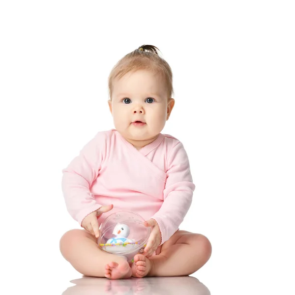 8 month infant child baby girl toddler sitting in pink shirt duck in ball toy isolated on a white — Stock Photo, Image