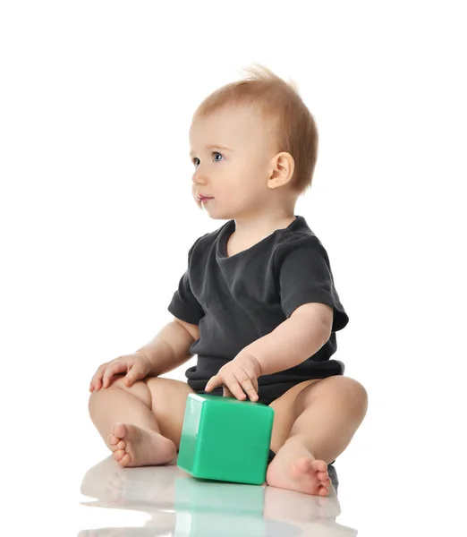 Infant child baby toddler sitting playing with green brick toy isolated on a white — Stock Photo, Image