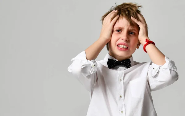 Young school boy screaming and crying close up on gray — Stock Photo, Image