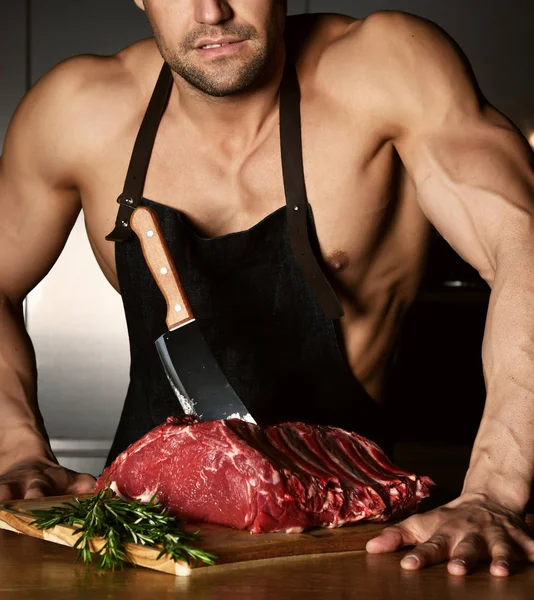 Strong sport man prepare cook beef steak ribs on dark kitchen healthy eating diet concept — Stock Photo, Image