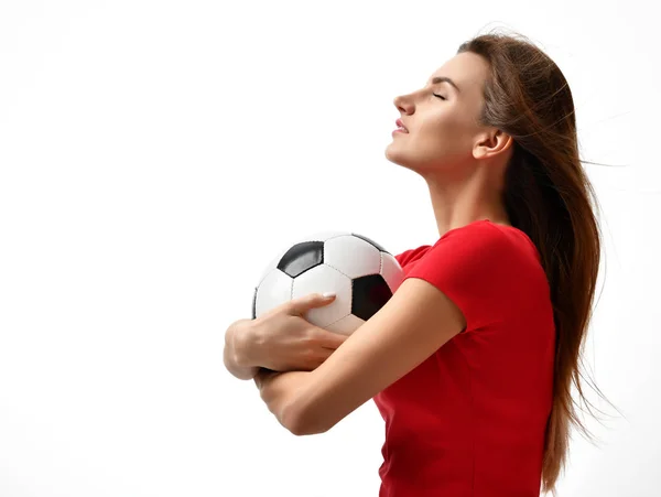 Γυναίκα παίκτη στην κόκκινη στολή κρατήστε ποδόσφαιρο μπάλα γιορτάζει βλέπουν τη γωνία closeup σύνθεση σε λευκό φόντο — Φωτογραφία Αρχείου