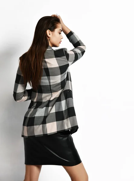 Young glamorous modern girl in a checkered jacket and black skirt wear red fashion glasses posing — 스톡 사진