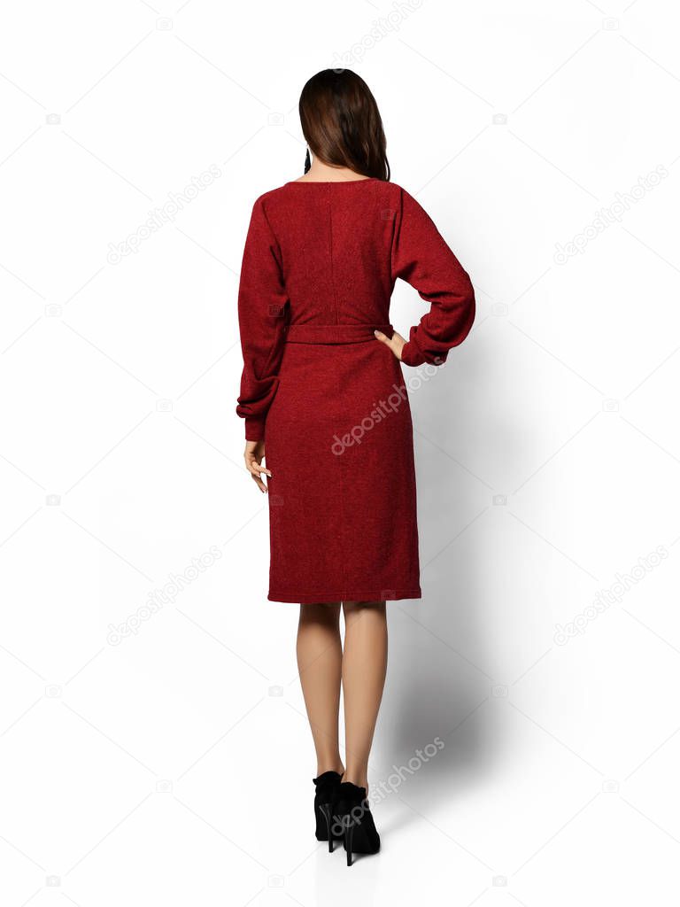 Young beautiful woman posing in new fashion casual dark purple red winter dress happy smiling walking
