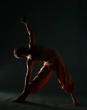 Gri sakallı yaşlı adam yoga, pilates, spor, esneme egzersizi, asana ya da yerde denge egzersizi yapıyor.