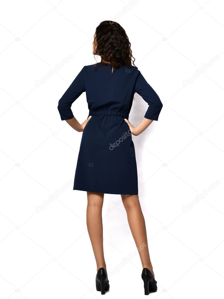 Young beautiful woman posing in new fashion casual trendy long dress walking backside view on white 