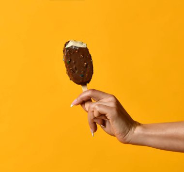 Sarı pastel üzerinde çilekli dondurma tutan kadın.