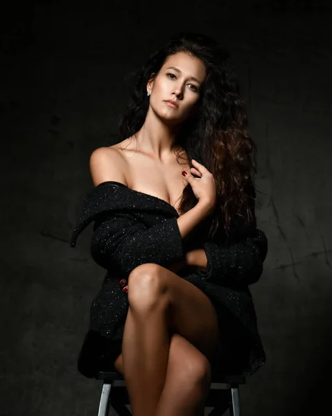 Portrait of sensual noble woman in tweed coat on the naked body sitting cross legged — Stock Photo, Image