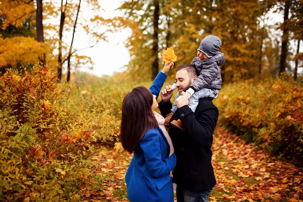 Happy family in autumn city park — Stock Photo, Image