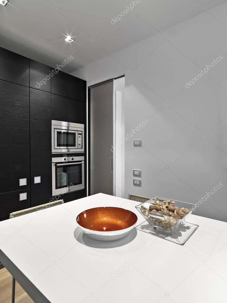 Interior shots of a modern kitchen with built-steel ovens