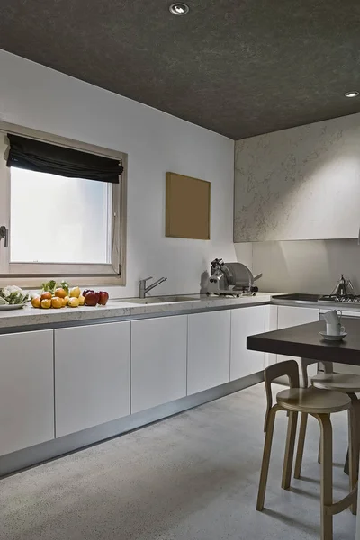 interiors shots of a modern kitchen with fruits fresh on the work top near to sink