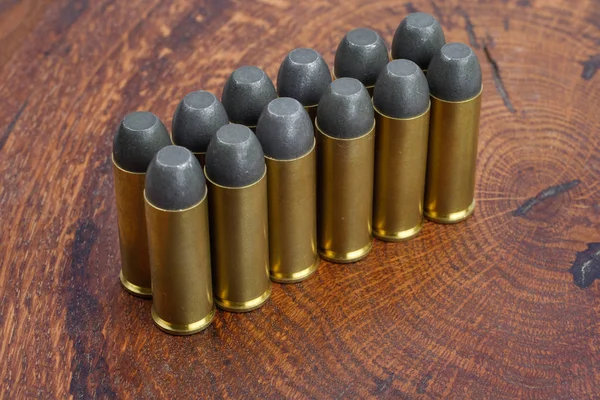 The .45 Revolver cartridges Wild West period on wooden background