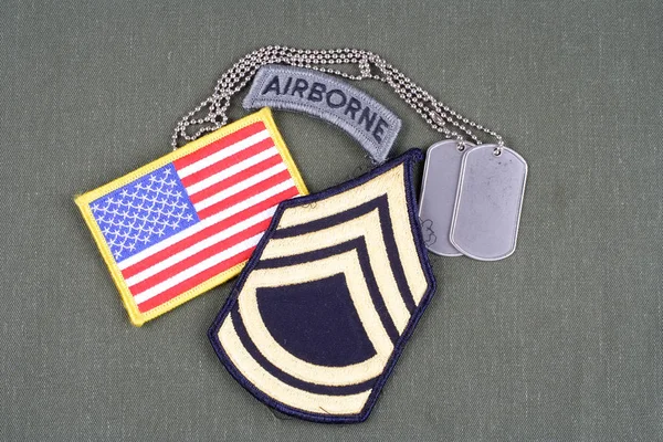 KIEV, UKRAINE - August 21, 2015.  US ARMY Sergeant First Class rank patch, airborne tab, flag patch and dog tag on olive green uniform — Stock Photo, Image