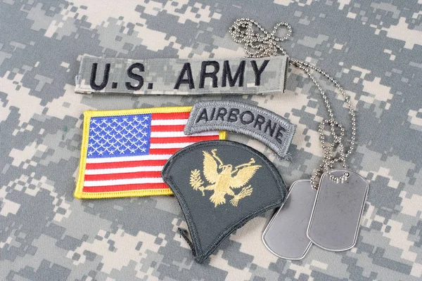 KIEV, UKRAINE - August 21, 2015. US ARMY Specialist rank patch, airborne tab, flag patch,  with dog tag on camouflage uniform — Stock Photo, Image