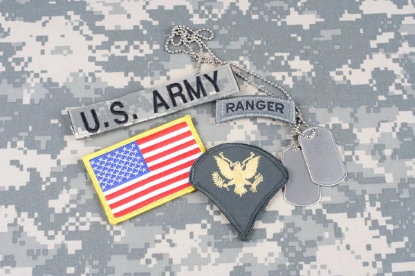 KIEV, UKRAINE - August 21, 2015. US ARMY Specialist rank patch, ranger tab, flag patch,  with dog tag on camouflage uniform — Stock Photo, Image
