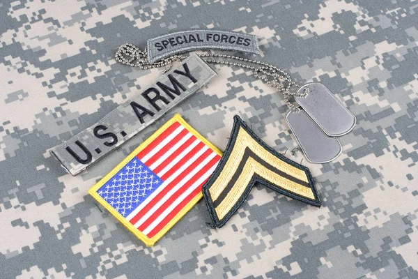 KIEV, UKRAINE - August 21, 2015. US ARMY Corporal rank patch, special forces tab, flag patch,  with dog tag on camouflage uniform — Stock Photo, Image