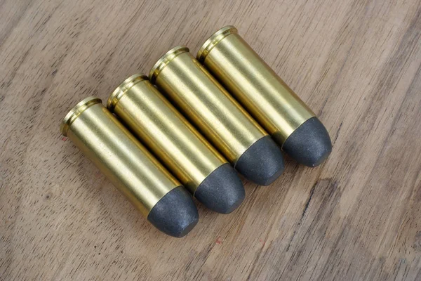 The .45 Revolver cartridges dating to 1872 on wooden background — Stock Photo, Image