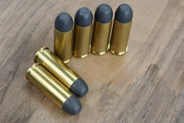 The .45 Revolver cartridges dating to 1872 on wooden background