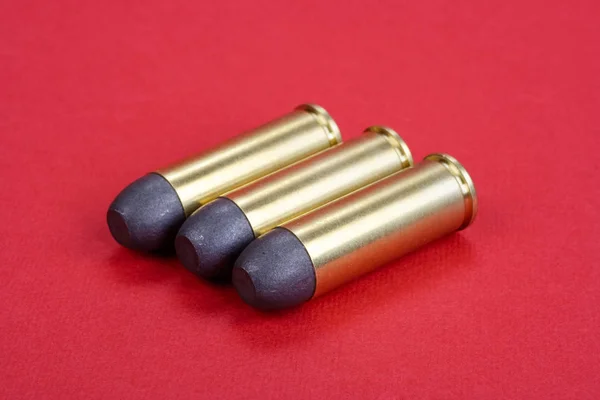 The .45 Revolver cartridges dating to 1872 on red background — Stock Photo, Image