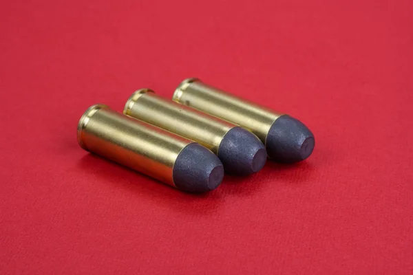 The .45 Revolver cartridges Wild West period on  red background — Stock Photo, Image