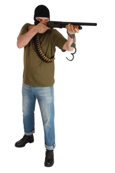 Jail break - robber in black mask with shotgun removing handcuffs — Stock Photo, Image