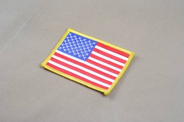 USA flag patch on desert camouflage uniform clipart