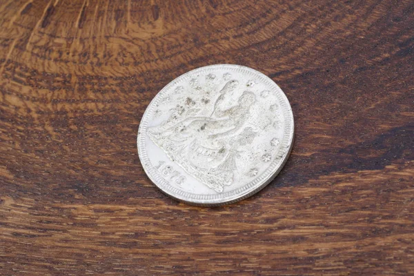 stock image old vintage silver dollar on wooden background