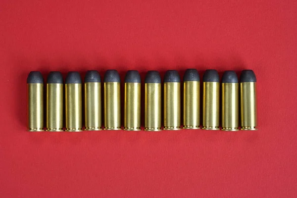 The .45 caliber revolver cartridges on red background