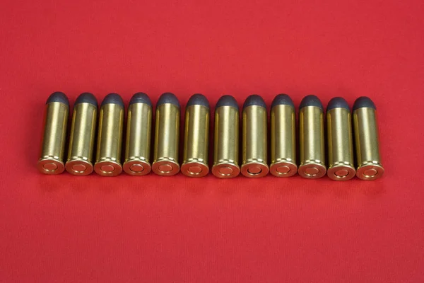 The .45 caliber revolver cartridges on red background