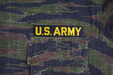 KIEV, UKRAINE - Sept 12, 2016. US ARMY branch tape on tiger stripe camouflage uniform clipart
