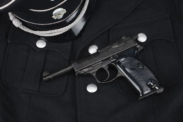WWII era nazi german waffen SS black uniform 1930 year pattern and army handgun — Stock Photo, Image