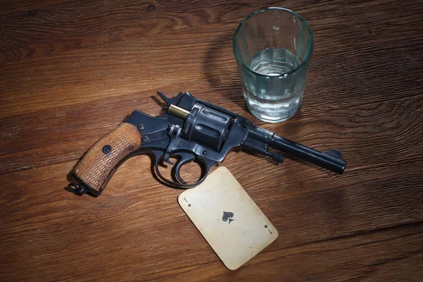 Russian roulette - Ace of Spades plaing card, glass of vodka and revolver with one cartridge in drum — Stock Photo, Image