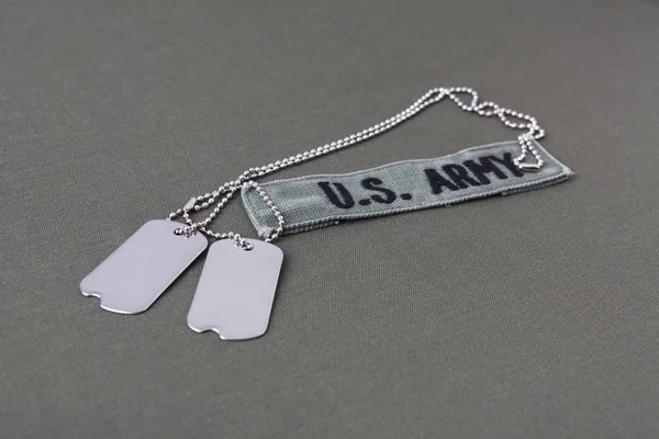 U.S. Army Branch Tape with dog tags on olive drab uniform — Stock Photo, Image