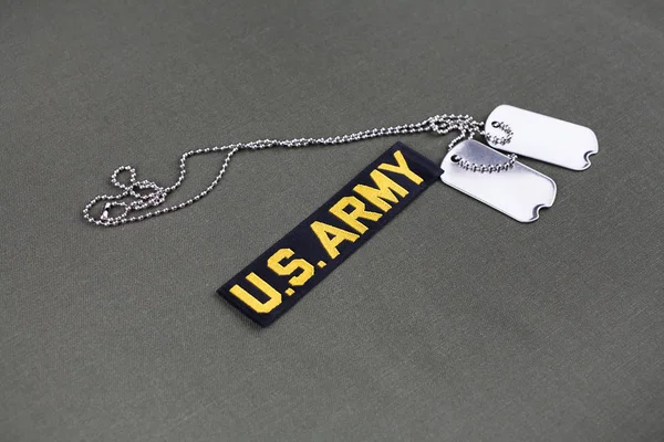 U.S. Army Branch Tape with dog tags on olive drab uniform — Stock Photo, Image