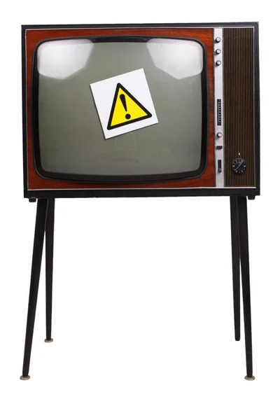 Eski model siyah beyaz TV ve sarı uyarı işareti. — Stok fotoğraf