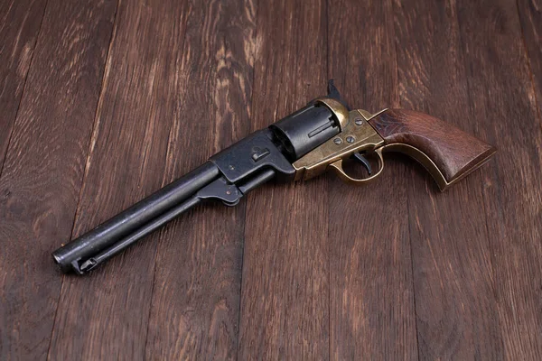 Firearms of the Old West - Percussion Army Revolver on wooden table