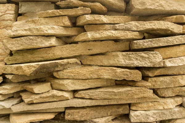 background of flat bright stones piled cobbles closeup