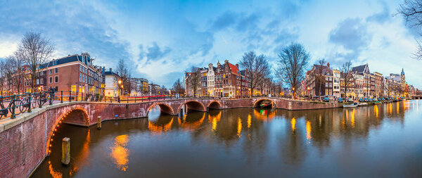 Amsterdam, Netherlands bridges and canals at twilight. 