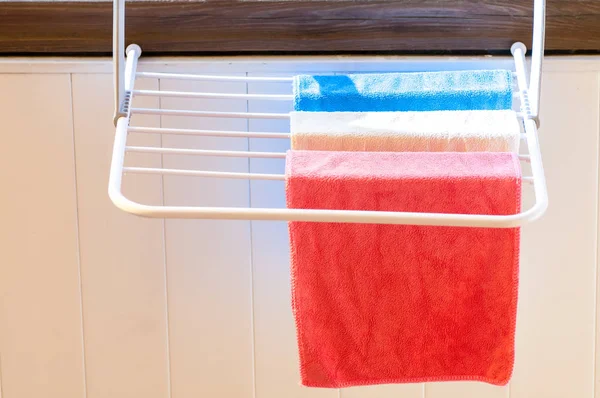 Three colored towels on the dryer close-up — Stock Photo, Image