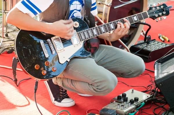 guitarist sets up an electric guitar before the concert begins o