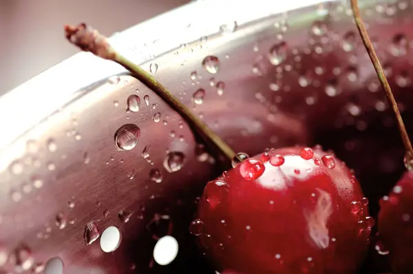 Berry black cherry with water drops in a colander close-up — Stock Photo, Image