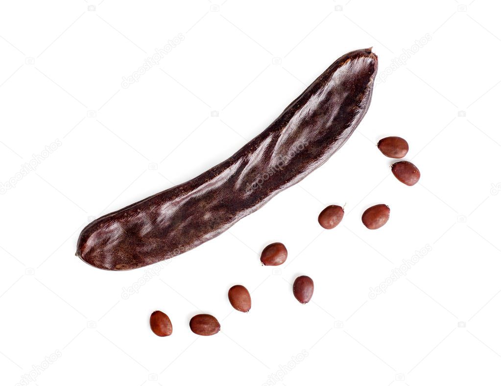 Seeds of a carob pod, close-up, top view, isolated