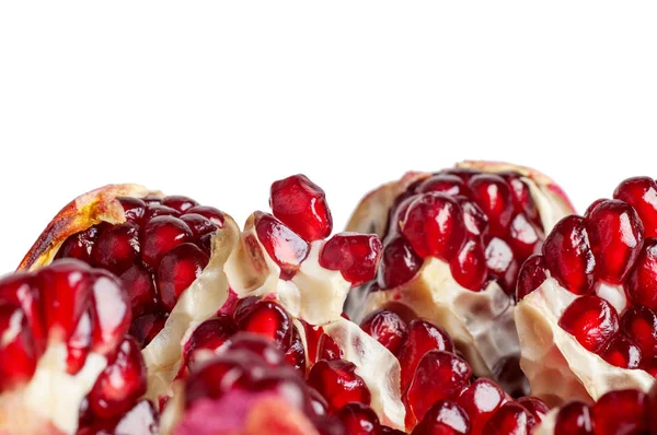 Many pomegranate slices close-up isolated on a white background — Stock Photo, Image