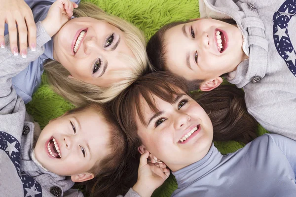 Rodzina szczęśliwa matka i dzieci relaksujący na zielono — Zdjęcie stockowe