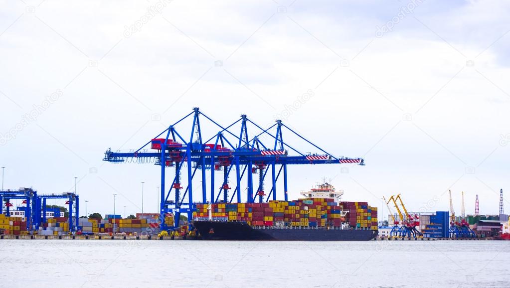 Tilt-shift panoramic view of sea port with ship, cargo, containe
