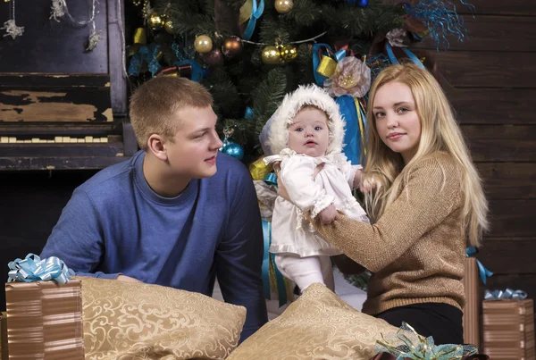 Parents with baby daughter at Christmas holiday. — Stock Photo, Image