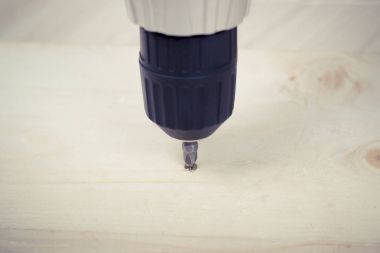 Birisi bir vida ahşap yüzey içine tornavida ile dalga geçiyor. DIY kavramı