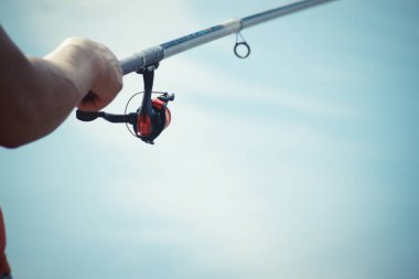 Balıkçı bir balık yakalar. Eller el closeup bir iplik çubuk ile balıkçı. Balıkçılık reel spin