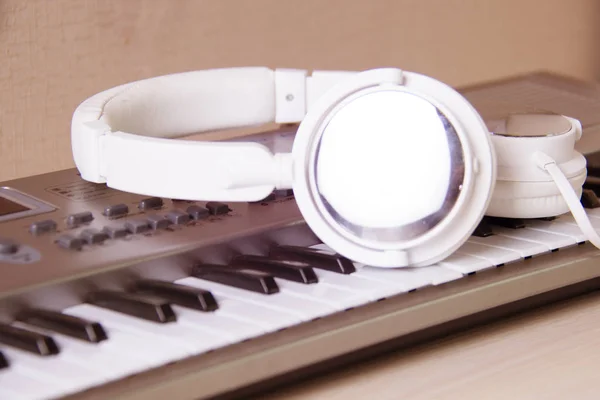 Headphones on musical synthesizer keyboard. Headphones on electronic piano.